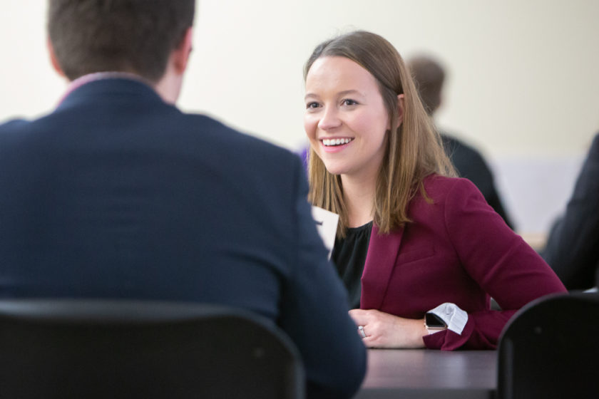 Two people sitting on either side of a table