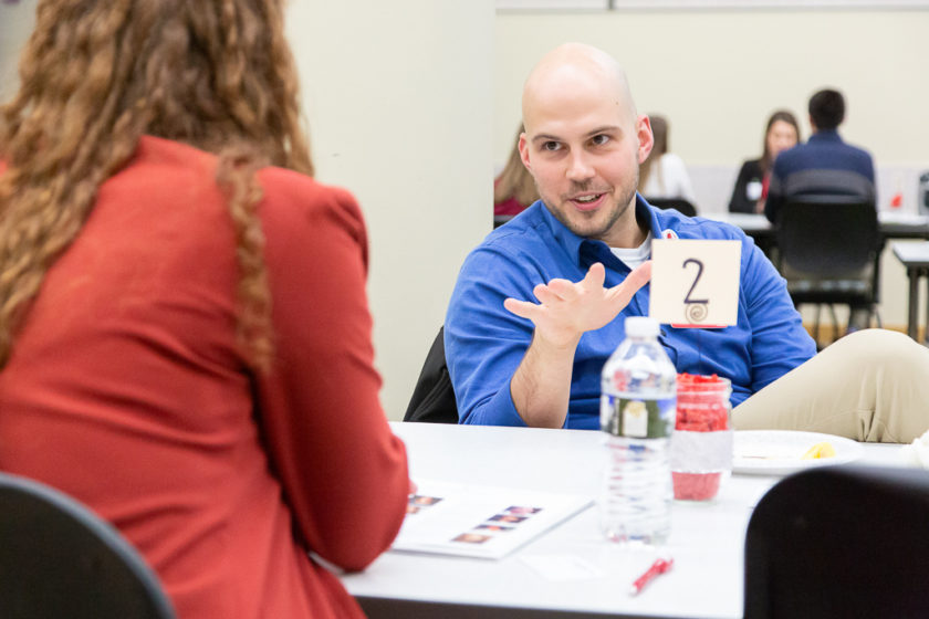 Two people speaking on either side of a table