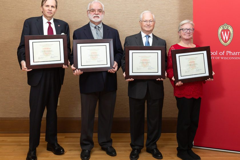 Award recipients together holding up their plaques