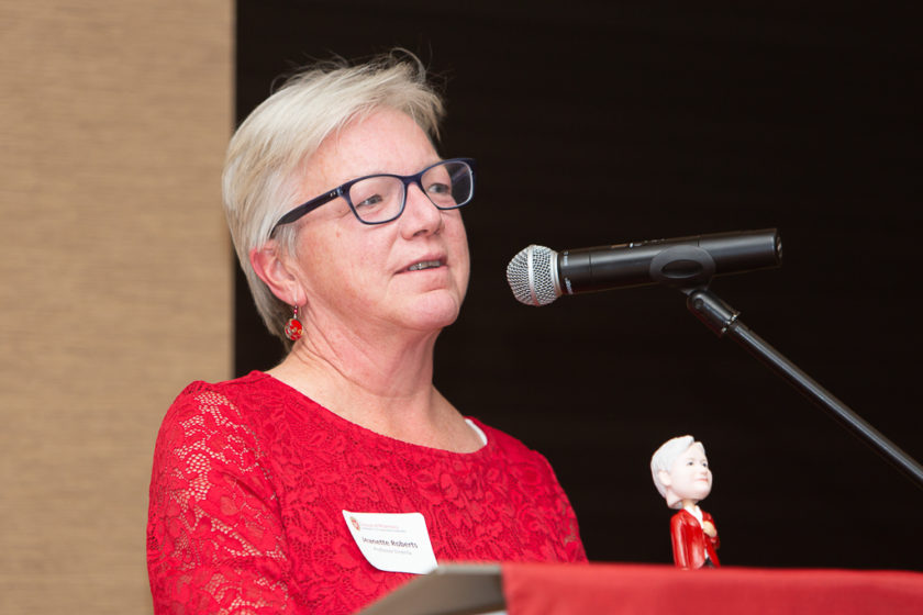 Jeanette Roberts, bobble head recipient, speaking at podium