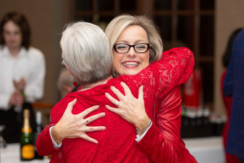 Staff hugging at Citations of merit dinner