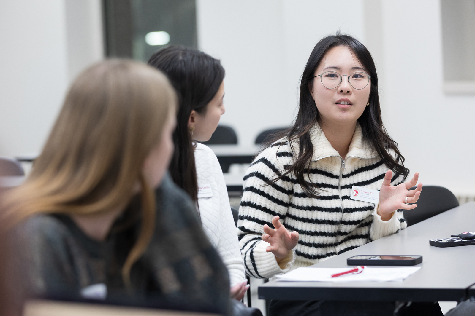 Yoonsoo Kim speaks with two other PharmD students.