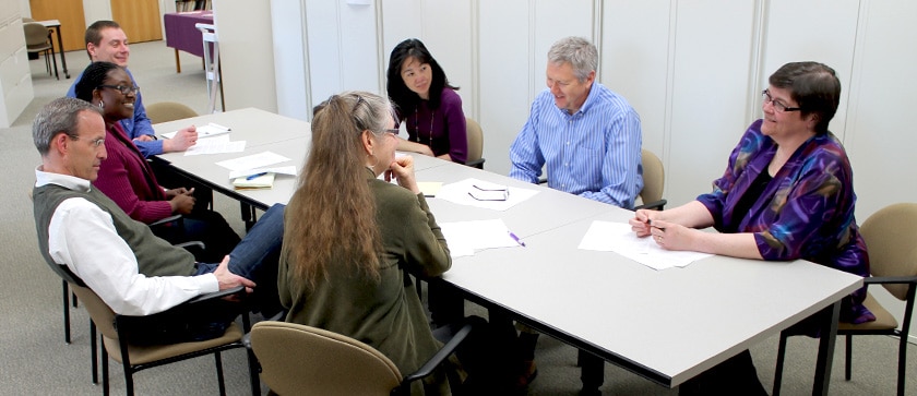 Sonderegger Research Center members sit around a table at a meeting