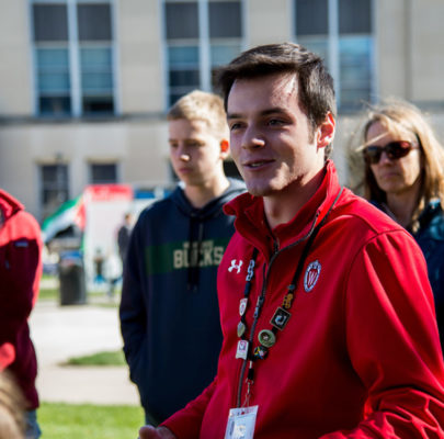 a tour guide shows prospective student families around the UW campus